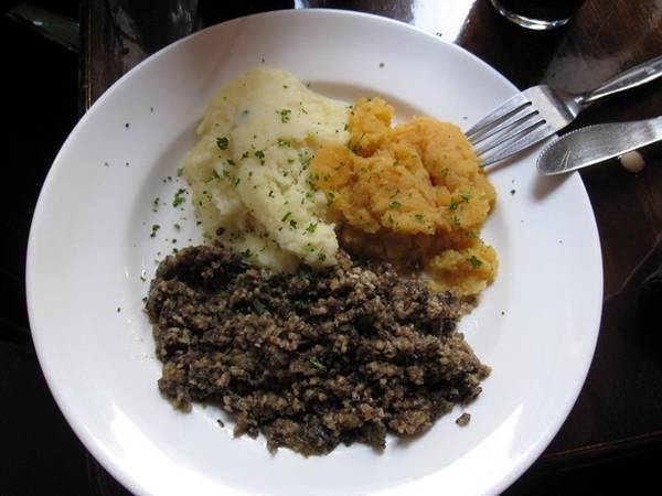  Scotland: Haggis gồm tim, gan, phổi của của cừu được nhồi vào dạ dày của con vật rồi nấu chín. Món ăn lạ lùng này thường được ăn kèm với rau và khoai tây. Ảnh: Flickr/brostad .