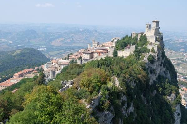 San Marino không phải là cái tên quen thuộc với người dân ngoài châu Âu. Đất nước tí hon này được biết đến nhiều hơn nhờ những cuộc đua Công thức 1 và Moto GP diễn ra tại Italy nhưng mang tên San Marino. Nhưng nơi đây lại sừng sững ba tòa tháp trên đỉnh Titano không thể nào bỏ qua với những tâm hồn phiêu du. San Marino nằm ở phía đông bắc Italy và bị bao bọc hoàn toàn bởi đất nước hình chiếc ủng. Là một trong những quốc gia nhỏ nhất thế giới với diện tích chỉ 61 km2, San Marino có đời sống thường nhật gần như gắn liền với "hàng xóm khổng lồ". An ninh quốc phòng của San Marino do Italy đảm nhận, hàng hóa thiết yếu được nhập khẩu, thậm chí mọi con đường giao thông vận tải đều phải đi qua nước này. Để tới San Marino, đại đa số du khách phải xuất phát từ thành phố biển Rimini của Italy cách đó gần một giờ đi buýt.