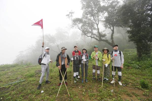 Đoàn leo núi lên đường từ sáng sớm, khi khung cảnh vẫn mờ trong sương.