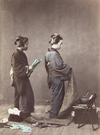 Một phụ nữ Nhật đang mặc kimono, quấn quanh eo bằng thắt lưng obi dài.