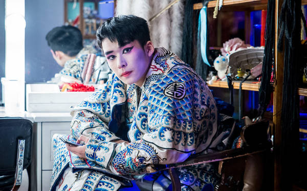 Một nghệ sĩ biểu diễn của nhà hát Tứ Xuyên trang điểm và mặc trang phục đầy màu sắc, đợi trong hậu trường tại một trong những quán trà lâu đời nhất Thành Đô.