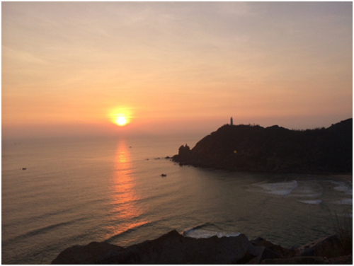 Ánh nắng mặt trời đầu tiên của Việt Nam mang một vẻ đẹp hoang sơ, cạnh đó là ngọn hải đăng Đại Lãnh lâu đời.