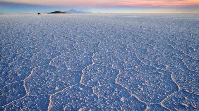 Trước đây, Salar de Uyuni thuộc một phần của hồ khổng lồ Minchin thời tiền sử. Mặt hồ là lớp muối có chiều dày từ vài cm đến vài m, mỗi năm cung cấp khoảng 10 tỷ tấn muối. Bên dưới chứa nhiều khoáng chất, đặc biệt là lithium (liti) dùng để sản xuất pin, chiếm một nửa trữ lượng trên thế giới. Vì vậy, đây không chỉ là địa điểm du lịch nổi tiếng mà còn là mỏ khoáng sản lớn của Bolivia.