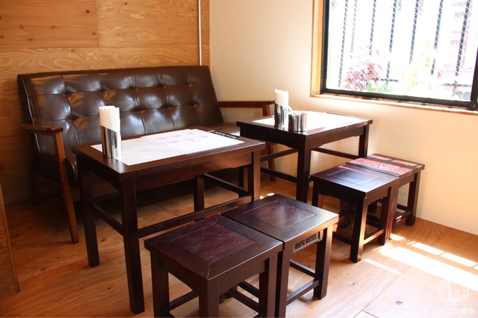 Thực khách có thể ngồi ghế sofa, ghế nhựa cứng hoặc tìm thấy loại bàn ghế gỗ màu trầm cũ kỹ và kiểu dáng giống hệt như ở cà phê Giảng Hà Nội. Ảnh: Hamakore.