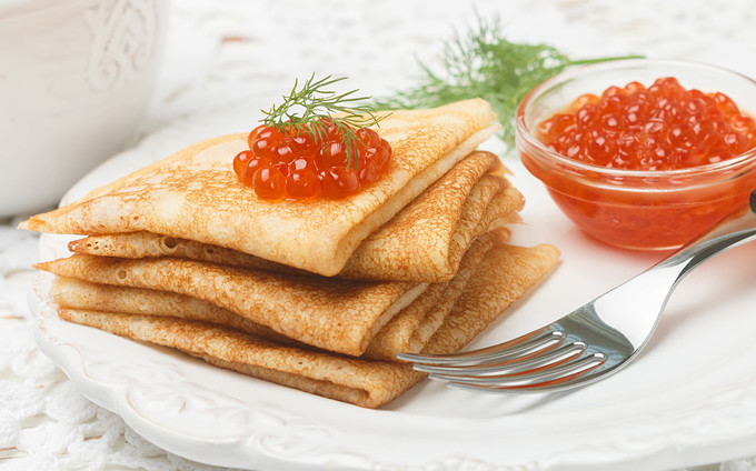 Blini  Blini là loại bánh pancake Nga mà du khách không thể bỏ qua. Điều đặc biệt là thực khách sẽ ăn kèm bánh với trứng cá hồi thượng hạng, hoặc thịt bằm.