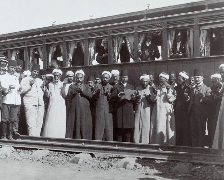 Năm 1909: Bức hình đầu tiên là khung cảnh một nghi lễ diễn ra tại điểm dừng ở nhà ga thành phố Medina vào năm 1909. Bên cạnh đó là hình ảnh thường ngày của những người phụ nữ vùng Trung Đông trong trang phục khá cũ nát và rườm rà. Ảnh: Col. F. R. Maunsell, Archibald Forder.