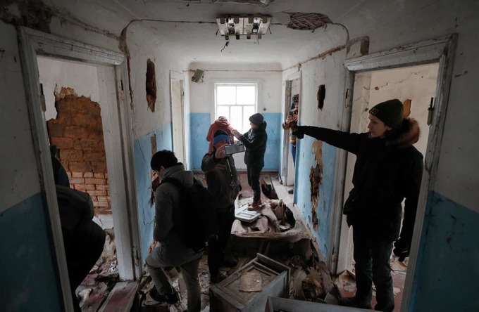 Rất nhiều du khách tìm hiểu, tham quan trong một tòa nhà bỏ không ở làng Zalissia.