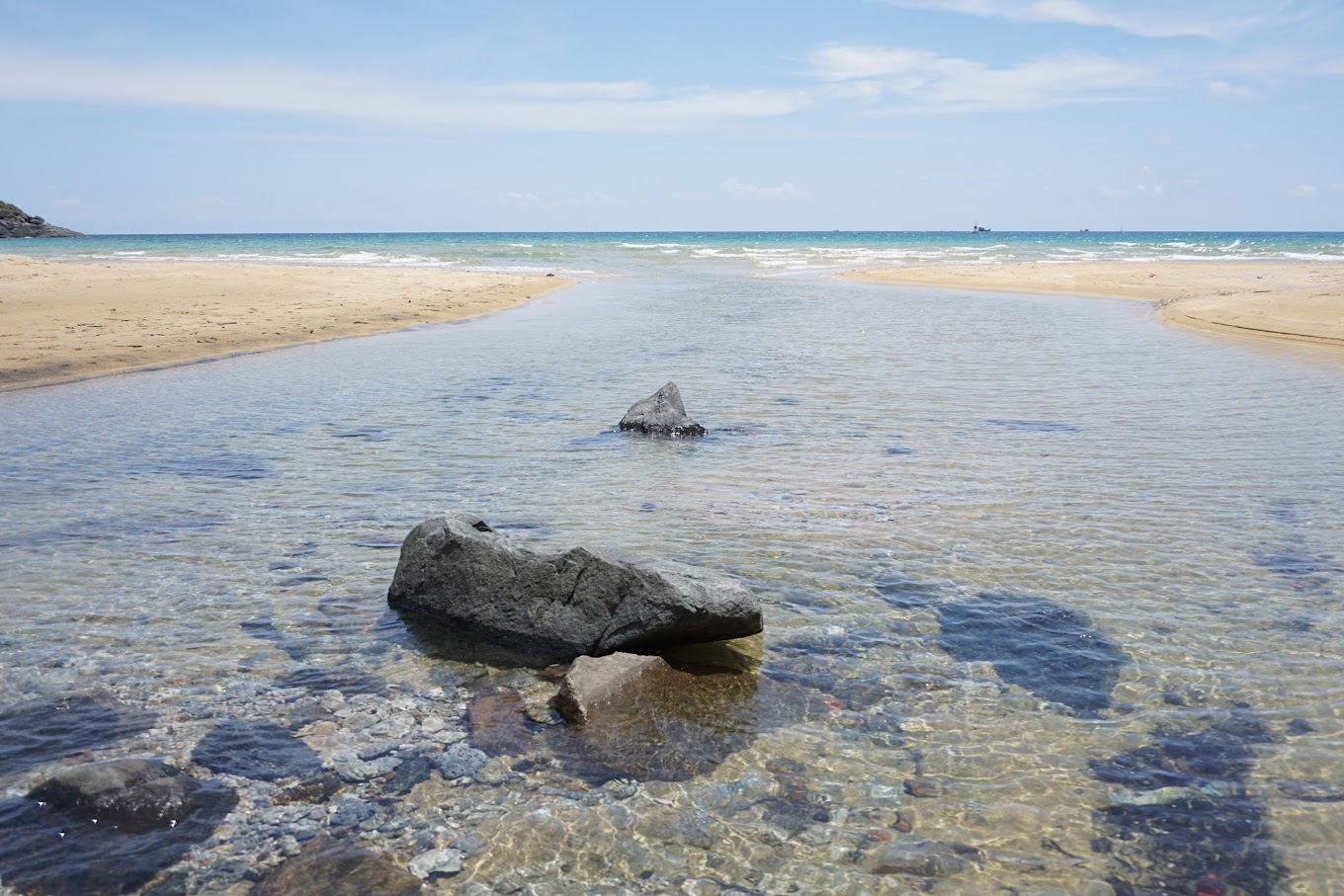 Wide stretch of clean sand and shallow water at Suoi Nong Beach